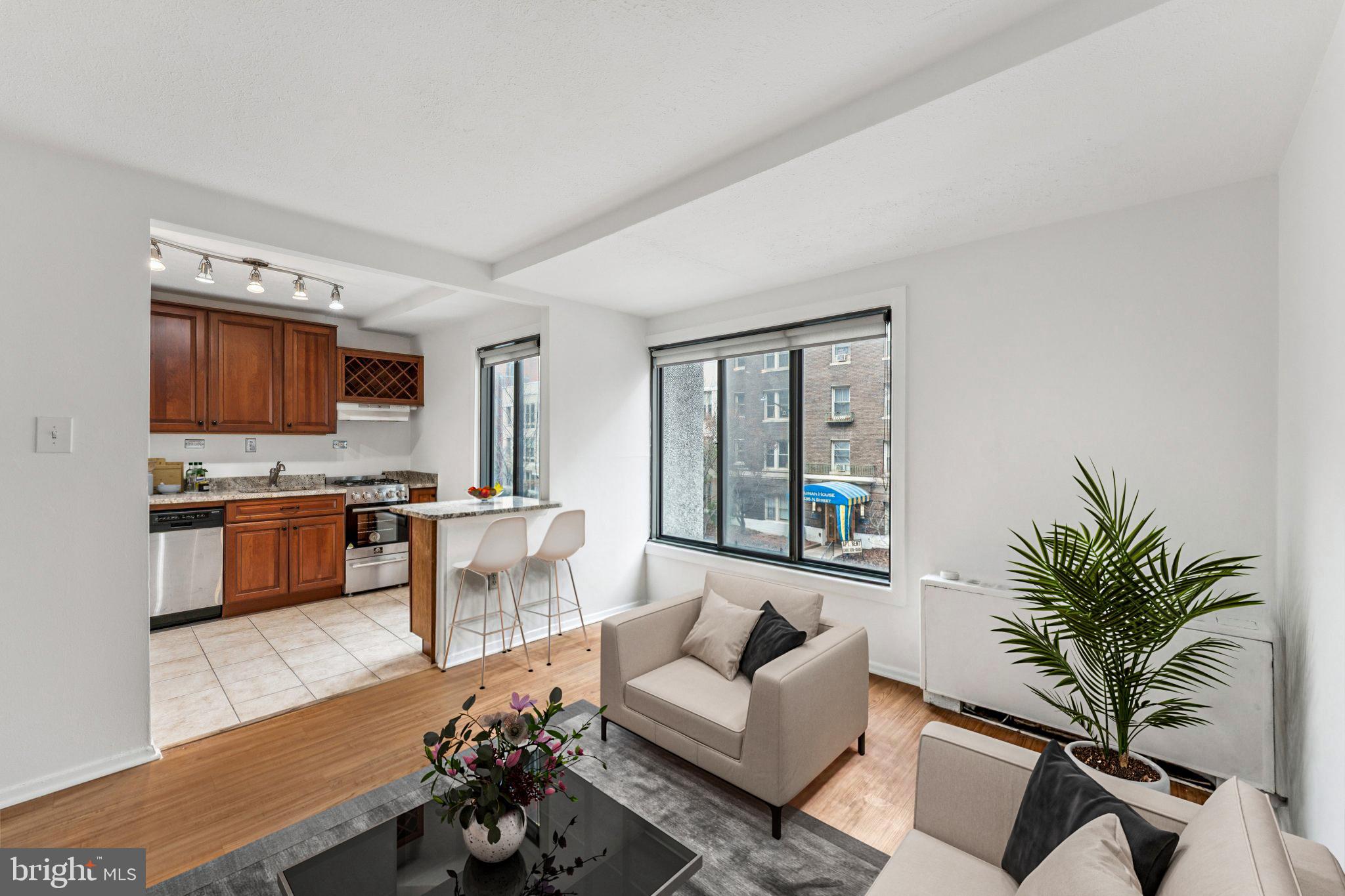 1440 N Street Northwest, Unit 312 Washington, DC 20005 - Photo 4 of 31 a living room with furniture and a flat screen tv