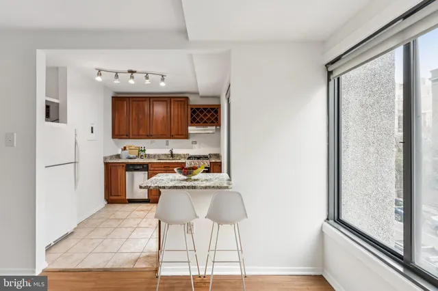 a kitchen with stainless steel appliances a stove refrigerator sink and microwave