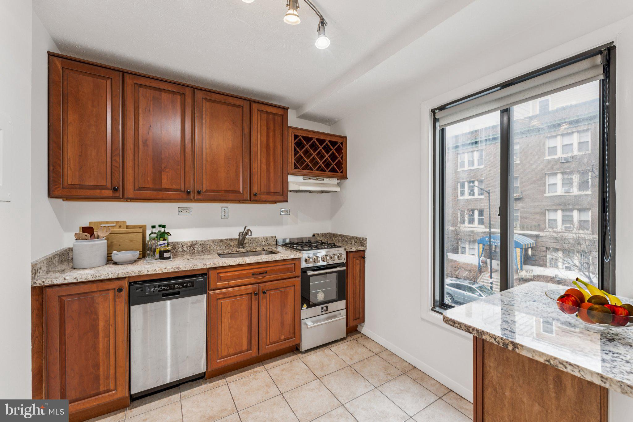 1440 N Street Northwest, Unit 312 Washington, DC 20005 - Photo 10 of 31 a kitchen with a sink stove and cabinets