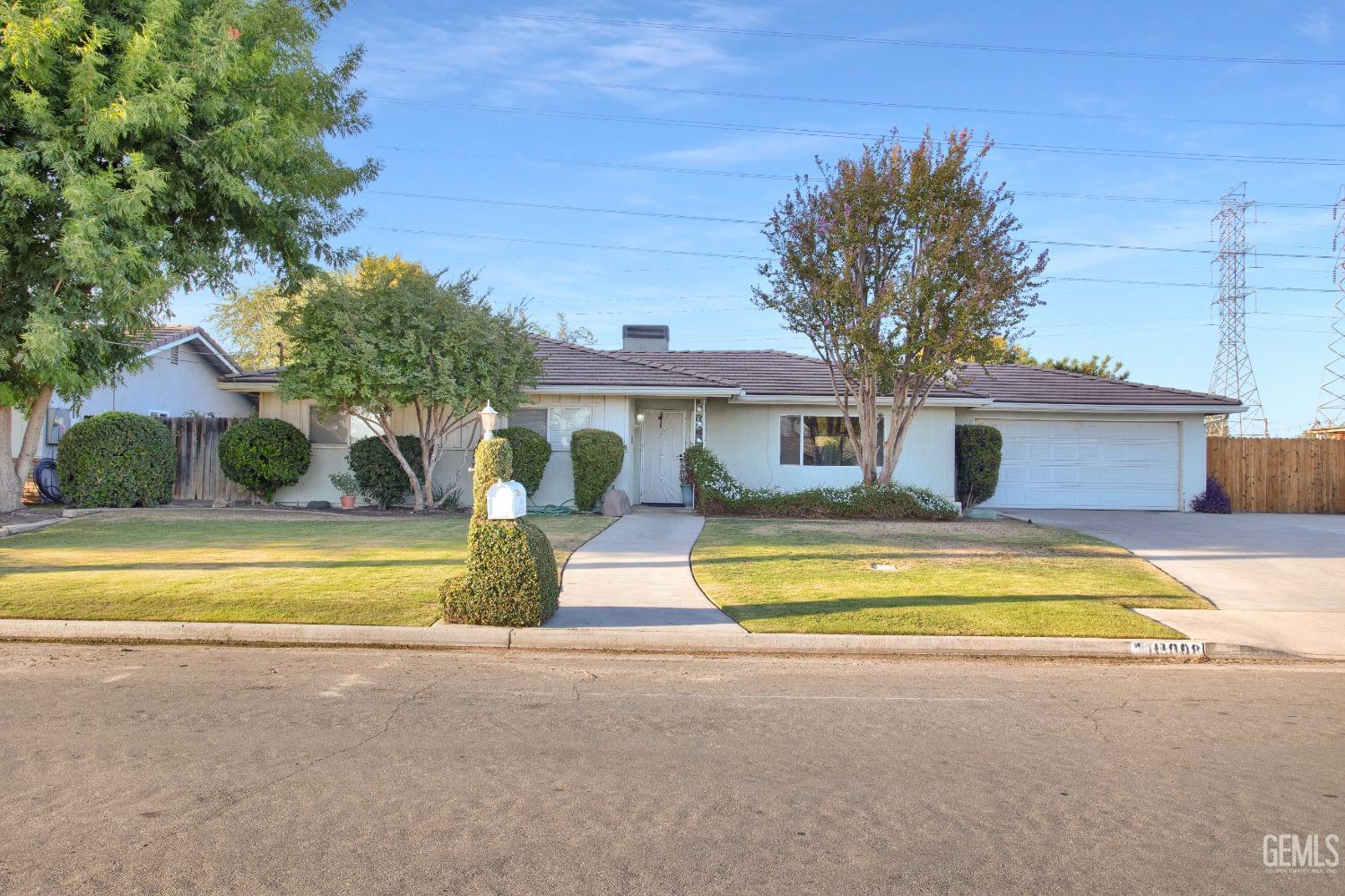a front view of a house with swimming pool and glass windows