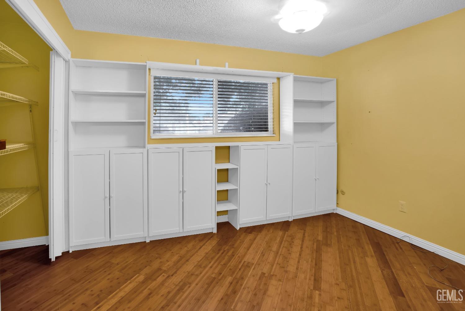 Undisclosed Address Bakersfield, CA 93312 - Photo 15 of 26 a view of an empty room with wooden floor and a window