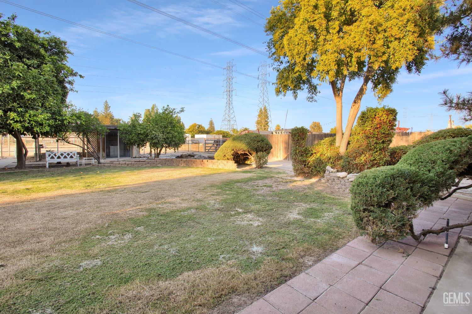 Undisclosed Address Bakersfield, CA 93312 - Photo 17 of 26 a view of a swimming pool with an outdoor seating and a yard