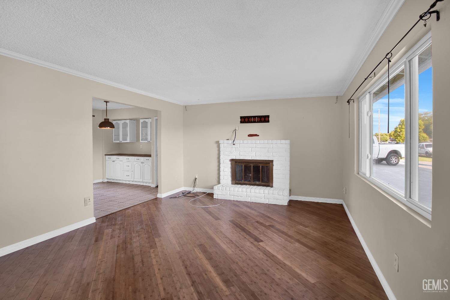 Undisclosed Address Bakersfield, CA 93312 - Photo 2 of 26 a view of empty room with wooden floor and fan