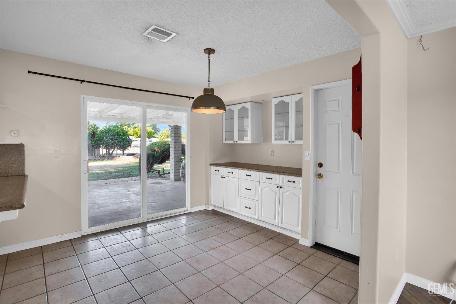 Undisclosed Address Bakersfield, CA 93312 - Photo 8 of 26 a kitchen with white cabinets and wooden floors