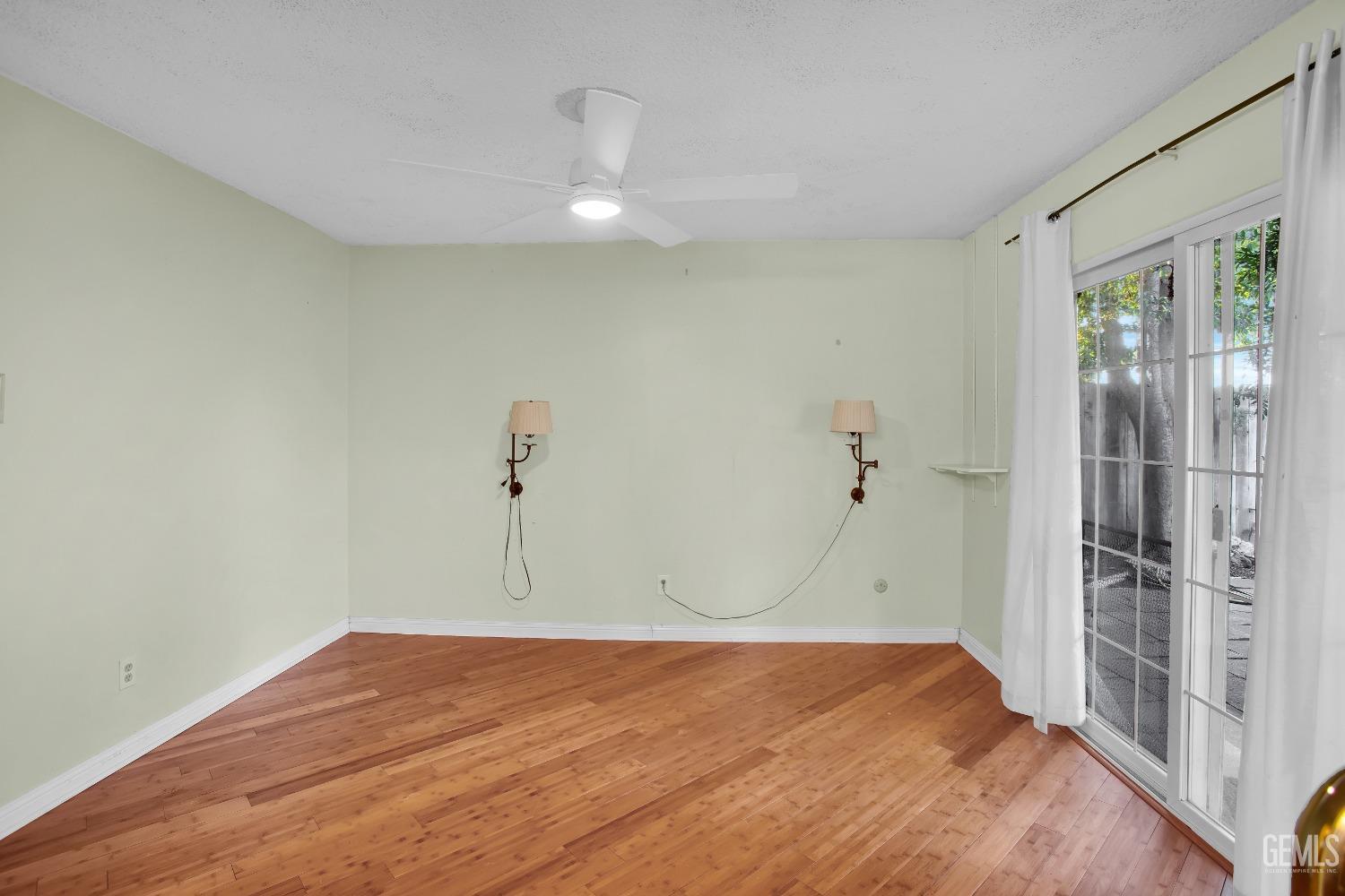 Undisclosed Address Bakersfield, CA 93312 - Photo 9 of 26 a view of empty room with wooden floor