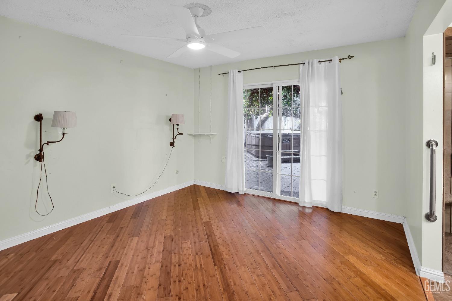 Undisclosed Address Bakersfield, CA 93312 - Photo 10 of 26 an empty room with wooden floor and windows