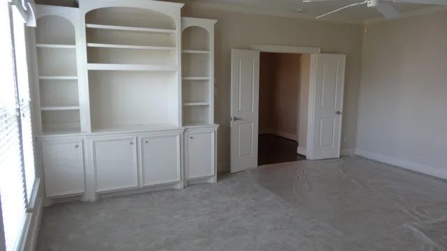 a view of an empty room with a closet