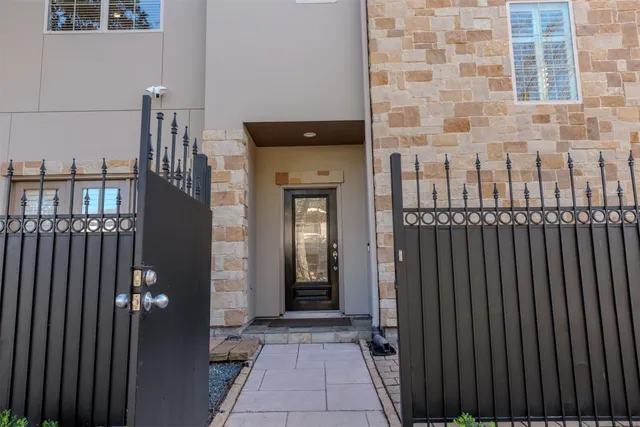 a view of a house with a door and wooden walls