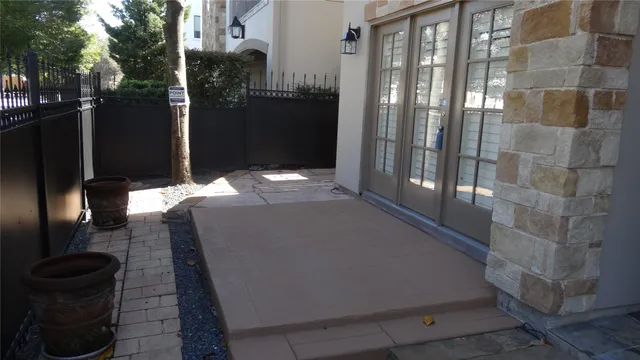 a view of a pathway with a wrought fence