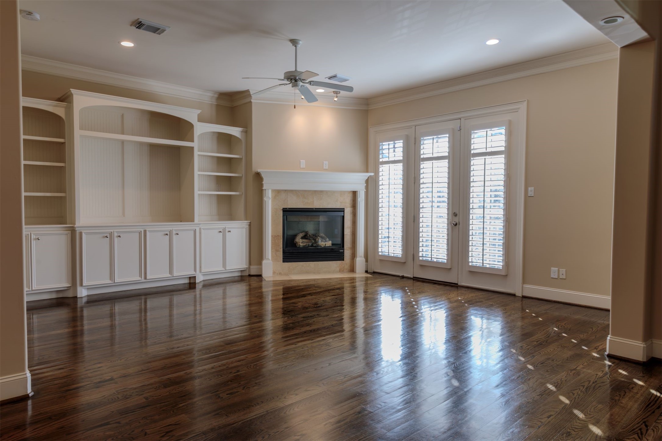 2101 Elmen Street Houston, TX 77019 - Photo 6 of 27 an empty room with wooden floor fireplace and windows