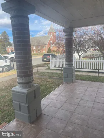 a view of a porch with a floor to ceiling window