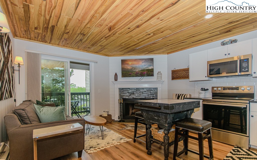 a living room with furniture a flat screen tv and a fireplace