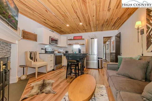 a living room with stainless steel appliances kitchen island granite countertop furniture and a kitchen view