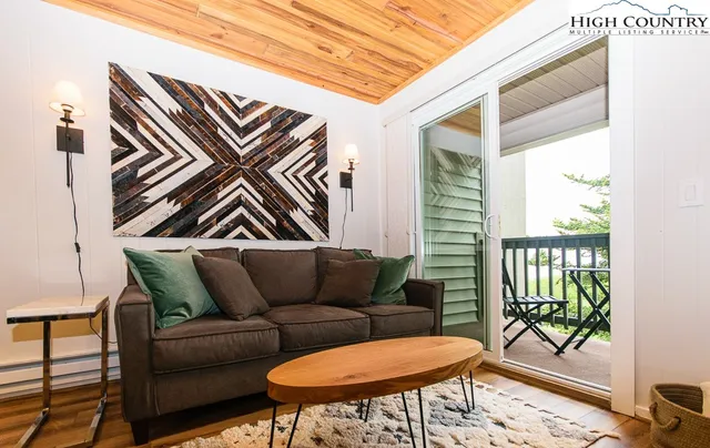 a blue couch sitting in front of a window