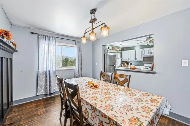 a dining room with a table chairs and wooden floor
