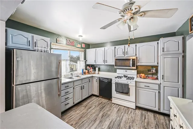 a kitchen with stainless steel appliances a refrigerator sink and cabinets