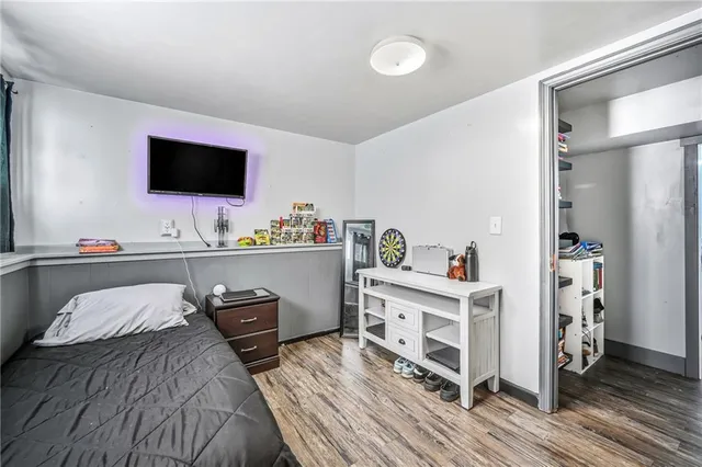 a bedroom with a bed and a flat screen tv