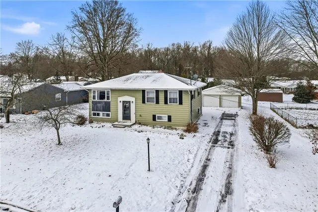 a view of a house with a yard covered in snow