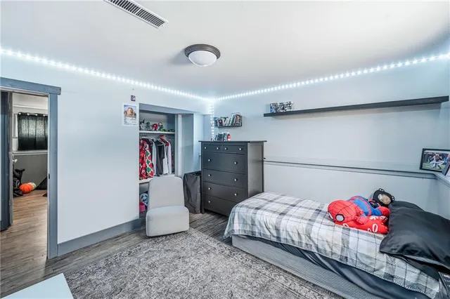 a bedroom with a bed and cabinets