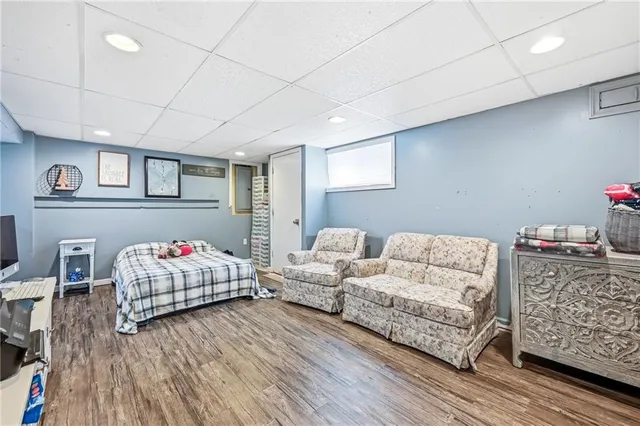 a bedroom with furniture and a wooden floor