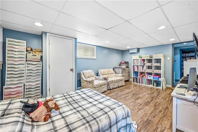 a bedroom with bed and a book shelf