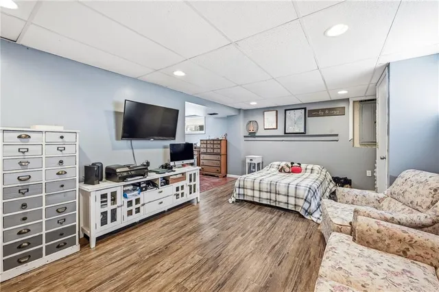 a bedroom with furniture and flat screen tv