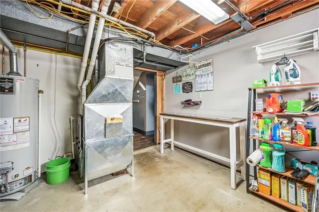 a room with lots of white furniture and a window