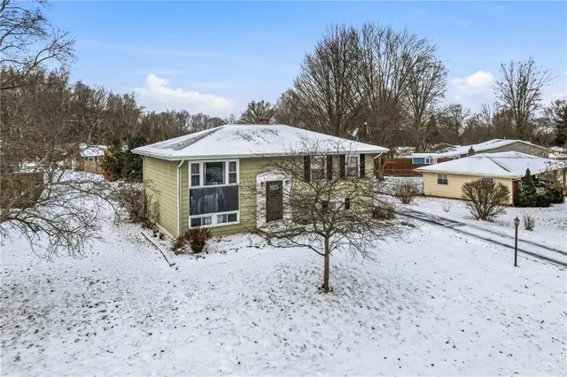 a view of a house with a yard and sitting area
