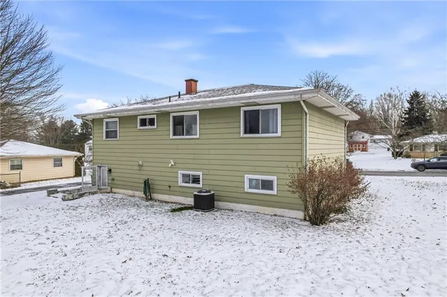 a view of a house with a yard and parking space