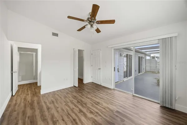 a view of empty room with wooden floor