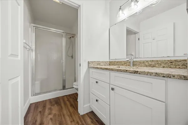 a bathroom with a granite countertop sink and a mirror