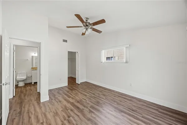 a view of empty room with wooden floor