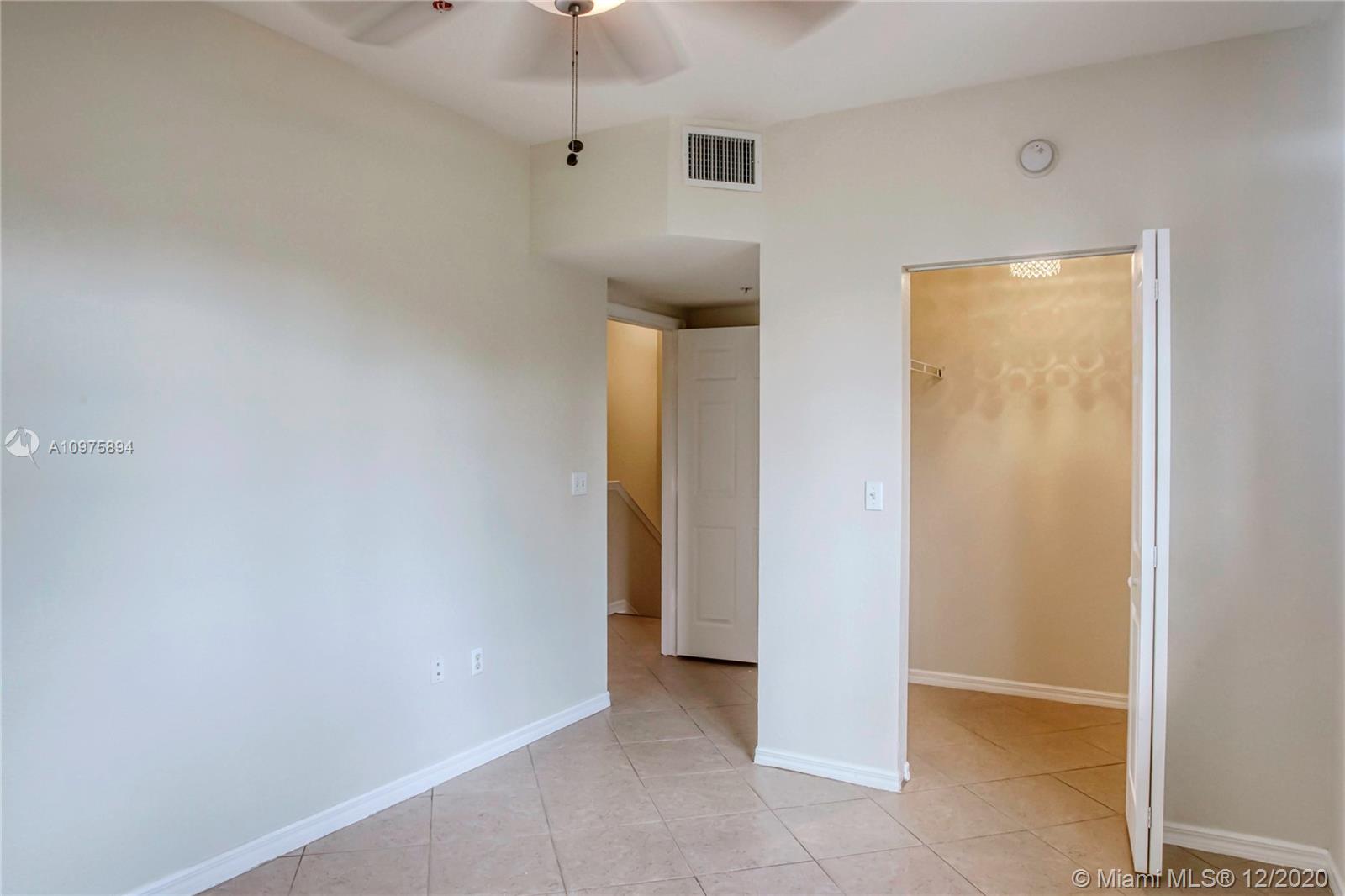 6400 West Sample Road, Unit 6400 Coral Springs, FL 33067 - Photo 13 of 23 Bedroom 1 and a walk-in closet (opened).