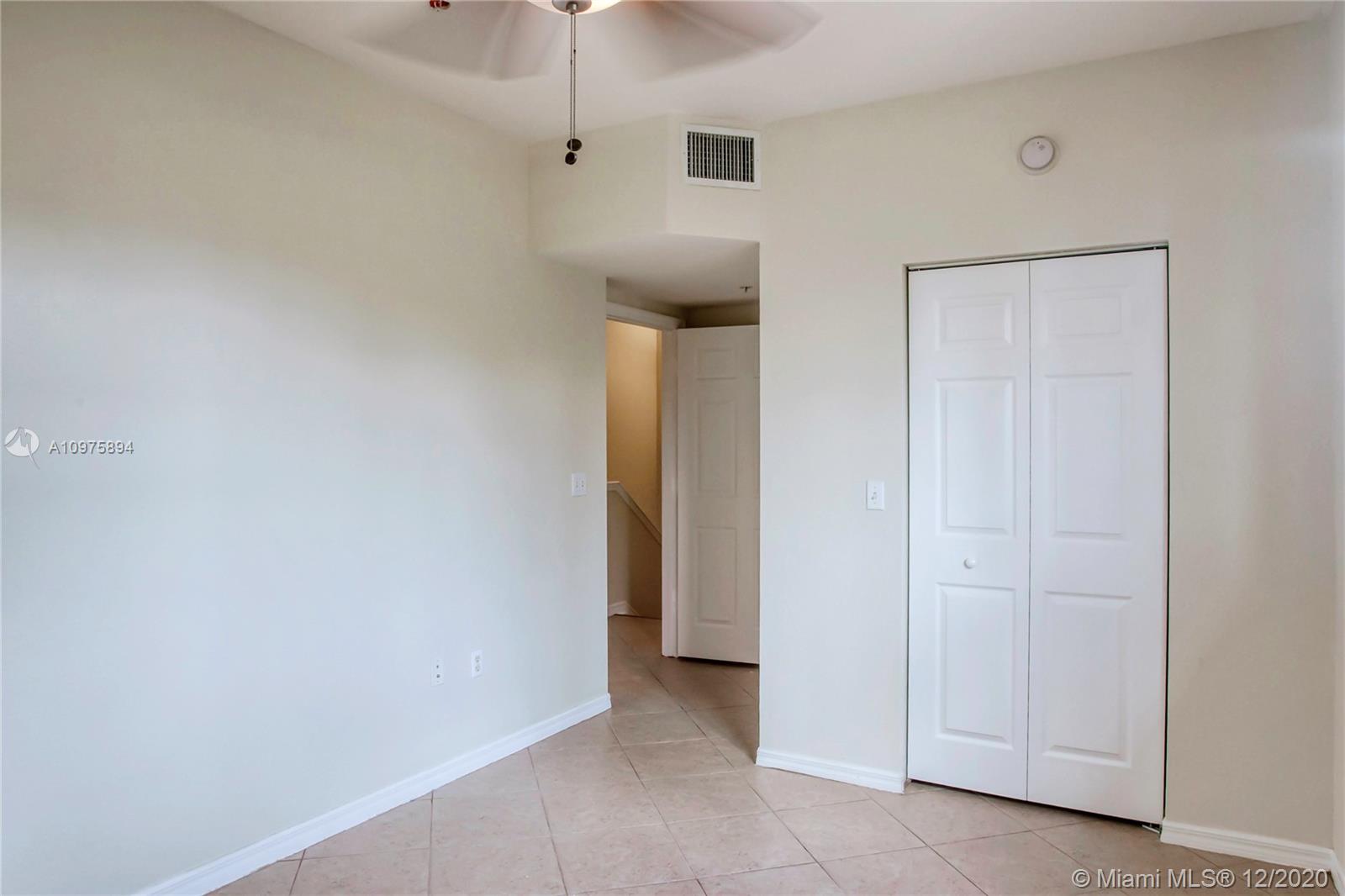 6400 West Sample Road, Unit 6400 Coral Springs, FL 33067 - Photo 14 of 23 Bedroom 1 and a walk-in closet (closed).