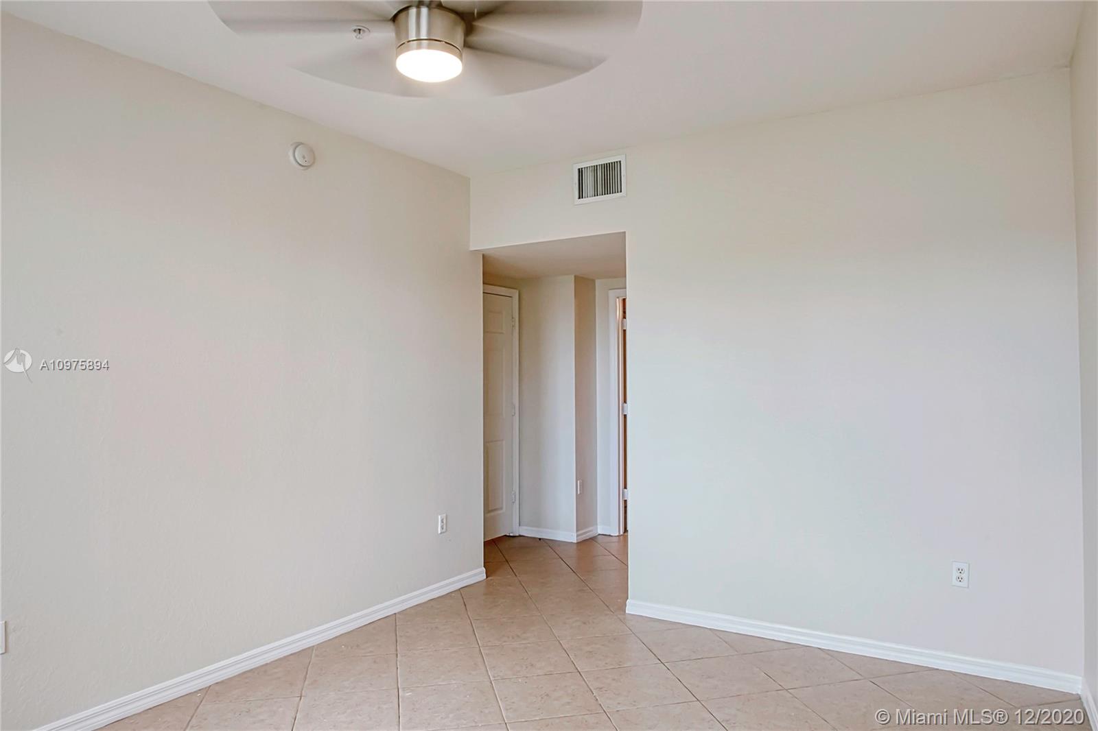 6400 West Sample Road, Unit 6400 Coral Springs, FL 33067 - Photo 17 of 23 Master bedroom and a way to the hallway, walk-in closet and master bathroom.