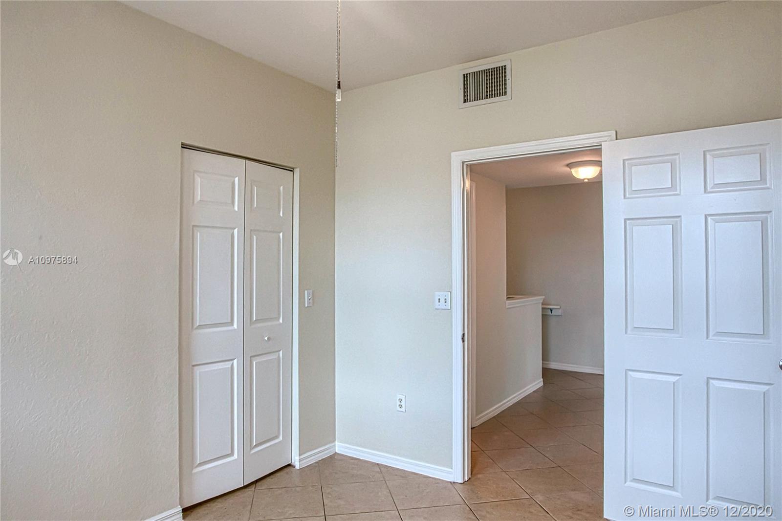6400 West Sample Road, Unit 6400 Coral Springs, FL 33067 - Photo 21 of 23 Bedroom 2 and a walk-in closet.
