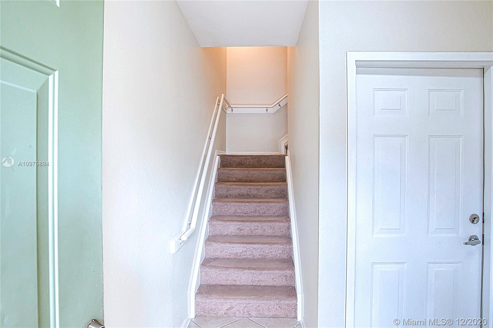 6400 West Sample Road, Unit 6400 Coral Springs, FL 33067 - Photo 4 of 23 Entrance: garage door and stairs to the living room and the kitchen