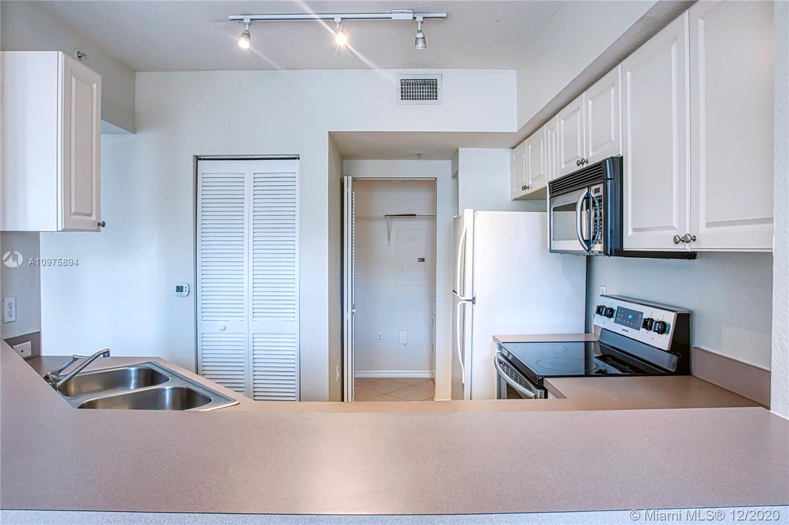 6400 West Sample Road, Unit 6400 Coral Springs, FL 33067 - Photo 7 of 23 Kitchen with a laundry room behind it.