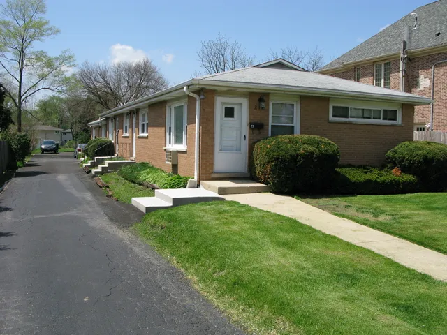 a front view of a house with a yard and porch