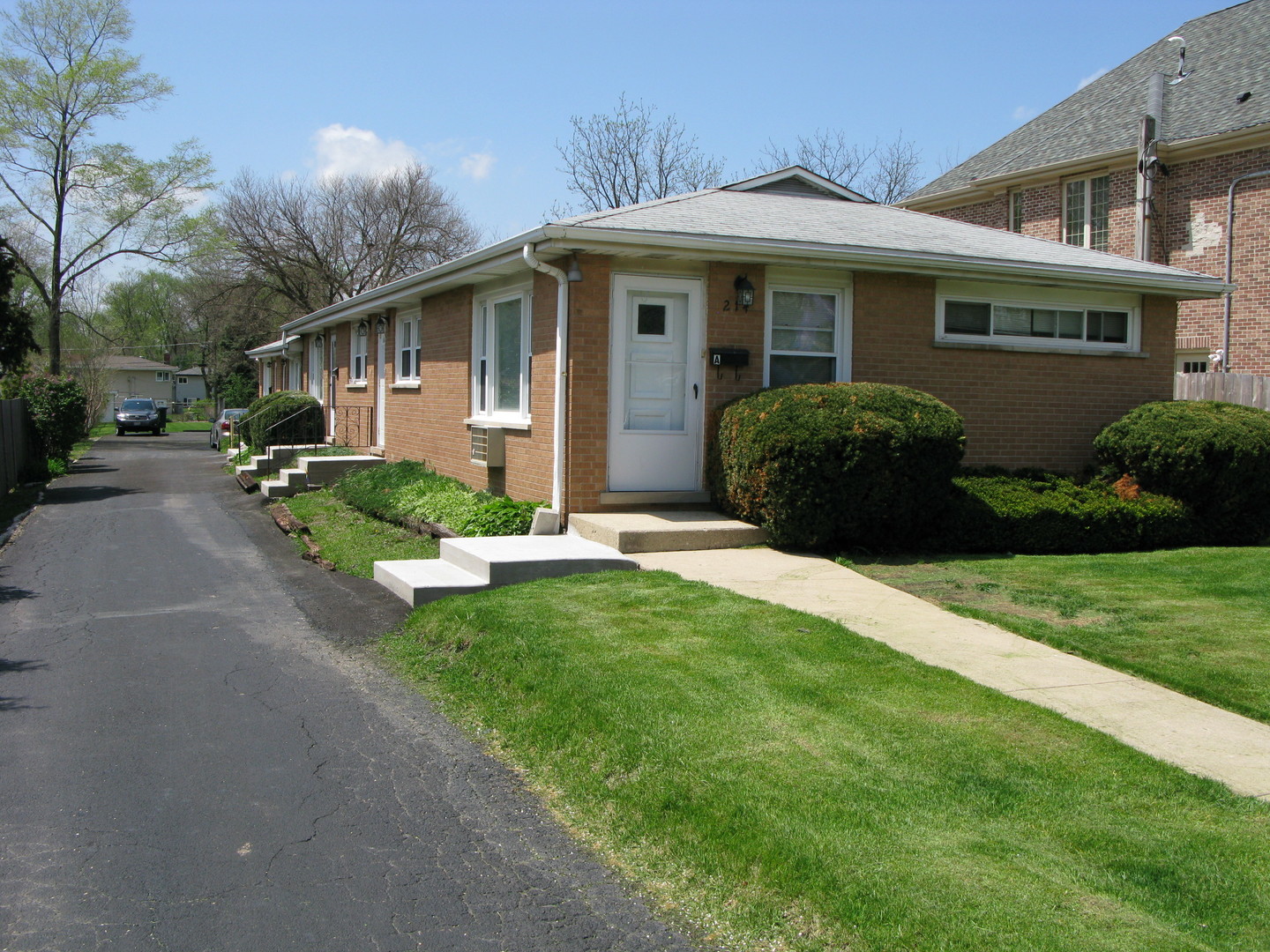 a front view of a house with a yard and porch