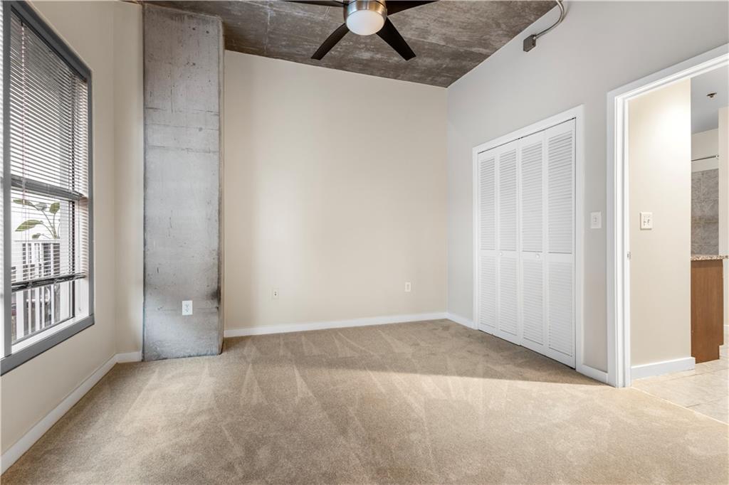 250 Pharr Road Northeast, Unit 308 Atlanta, GA 30305 - Photo 12 of 35 an empty room with windows and closet