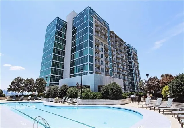a view of a swimming pool with outdoor seating