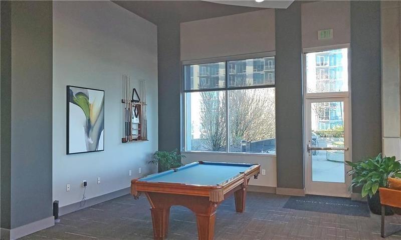 250 Pharr Road Northeast, Unit 308 Atlanta, GA 30305 - Photo 30 of 35 a room with pool table and windows