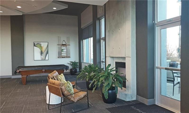 250 Pharr Road Northeast, Unit 308 Atlanta, GA 30305 - Photo 31 of 35 a living room with furniture and a potted plant