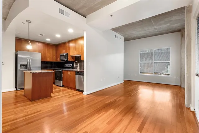 a view of kitchen with cabinets and wooden floor
