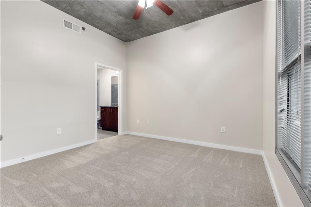 250 Pharr Road Northeast, Unit 308 Atlanta, GA 30305 - Photo 7 of 35 an empty room with a empty space and a window