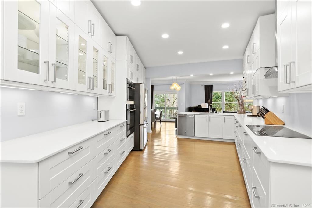 13 Old Stamford Road, Unit 13 New Canaan, CT 06840 - Photo 11 of 39 a large white kitchen with lots of counter space wooden floor and appliances