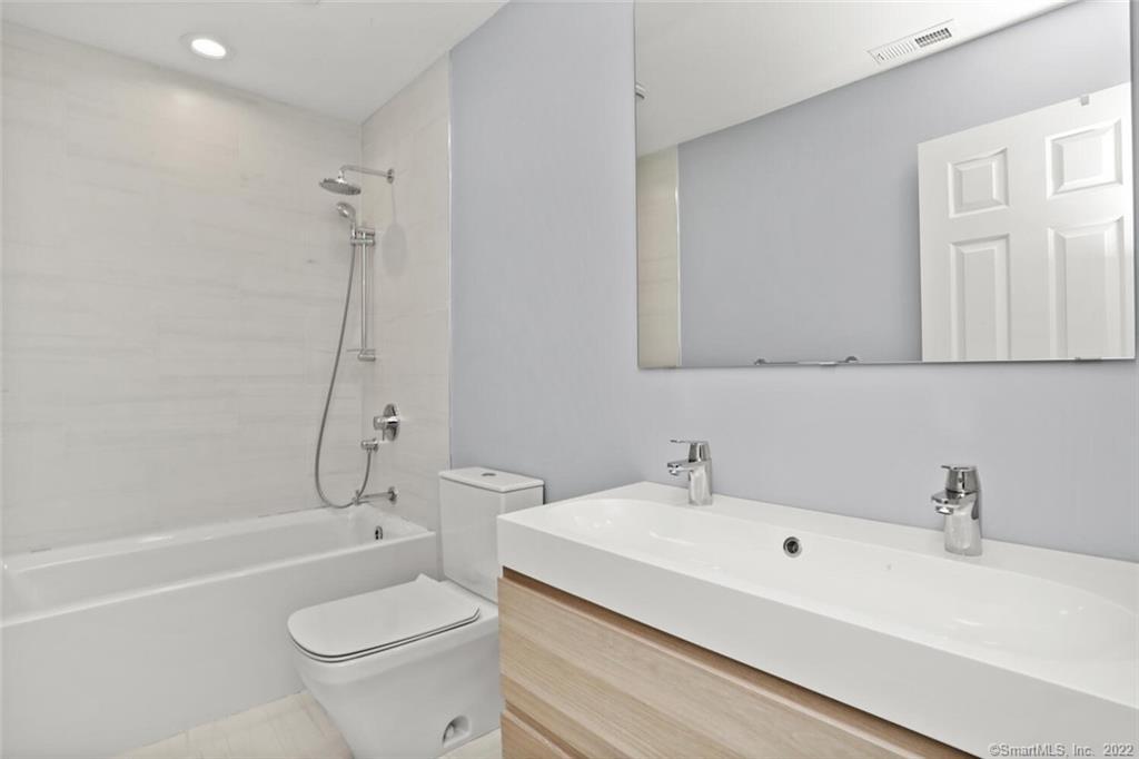 13 Old Stamford Road, Unit 13 New Canaan, CT 06840 - Photo 18 of 39 a bathroom with a sink a toilet and a bathtub