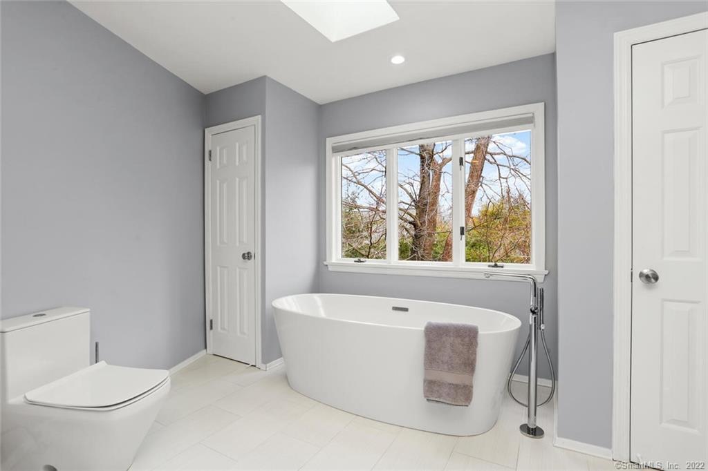 13 Old Stamford Road, Unit 13 New Canaan, CT 06840 - Photo 20 of 39 a white bath tub sitting next to a toilet