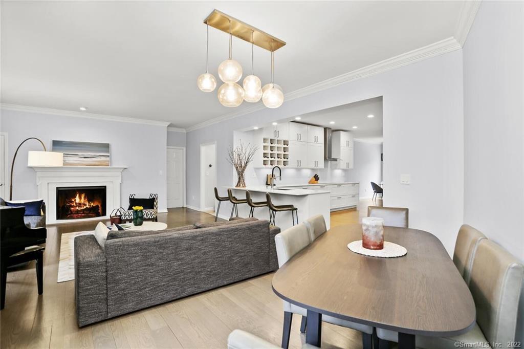 13 Old Stamford Road, Unit 13 New Canaan, CT 06840 - Photo 2 of 39 a living room with fireplace furniture and a chandelier